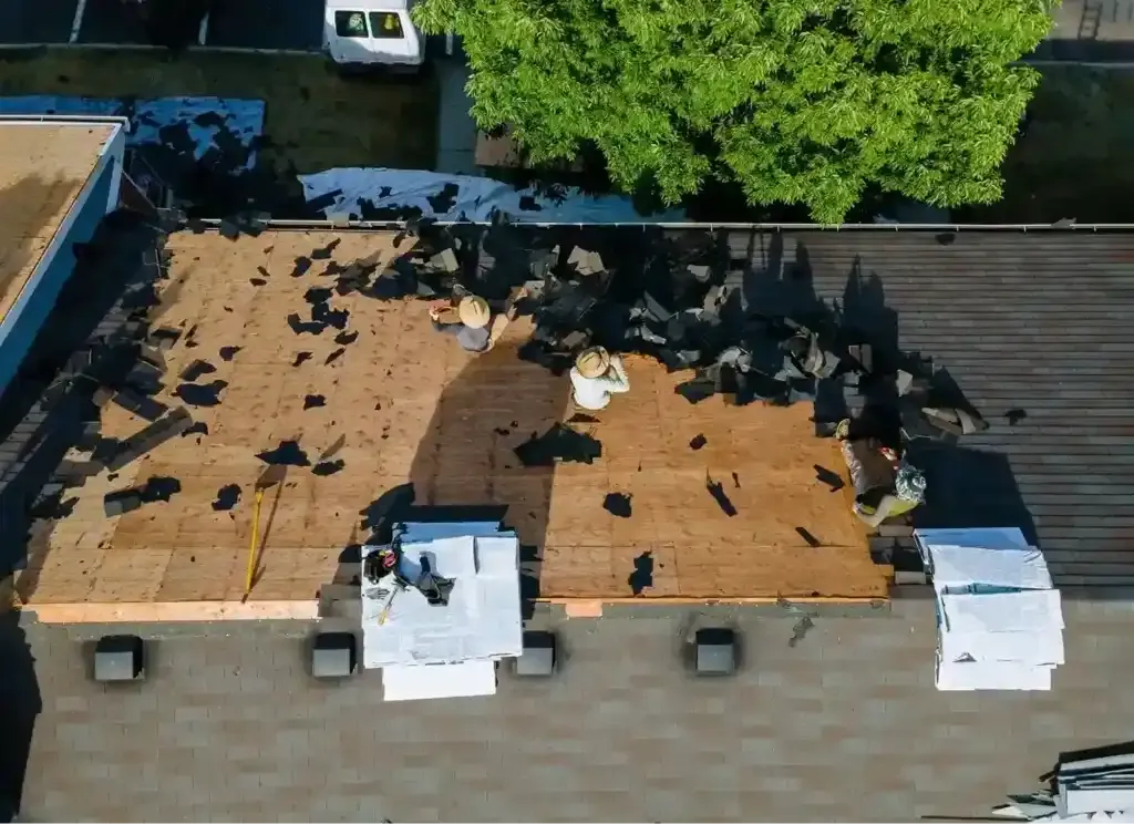 Crew preparing a roof for new materials