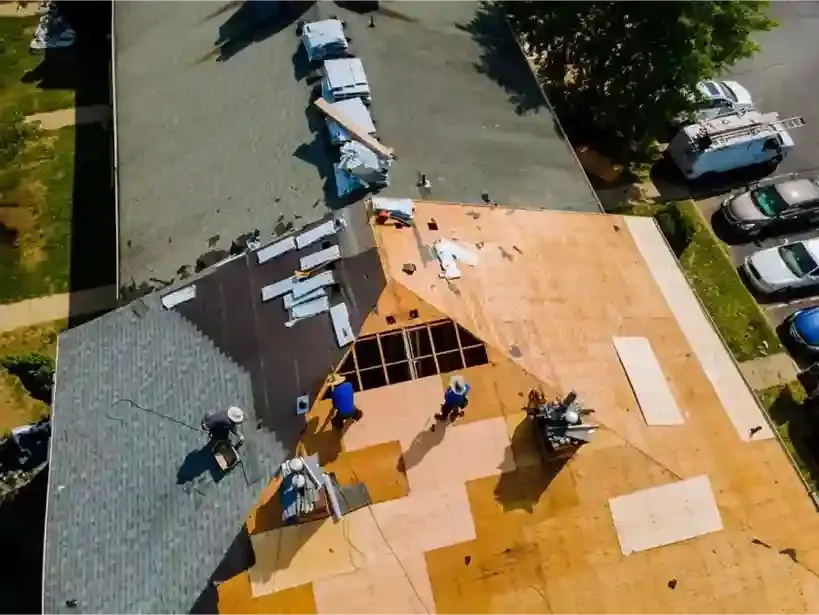 Roofing crew removing old roof material