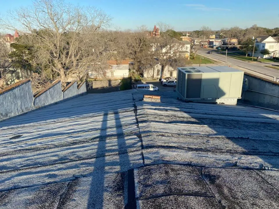Low-slope roof with rooftop equipment.