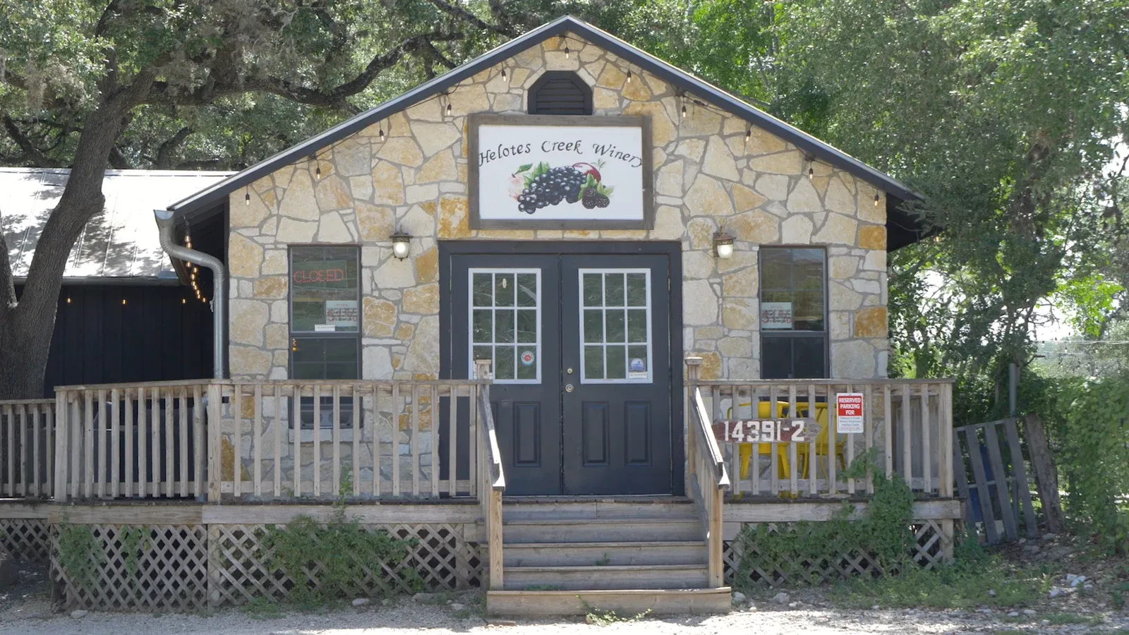 The stone front and metal roof of Helotes Creek Winery in Old Town Helotes, Texas.