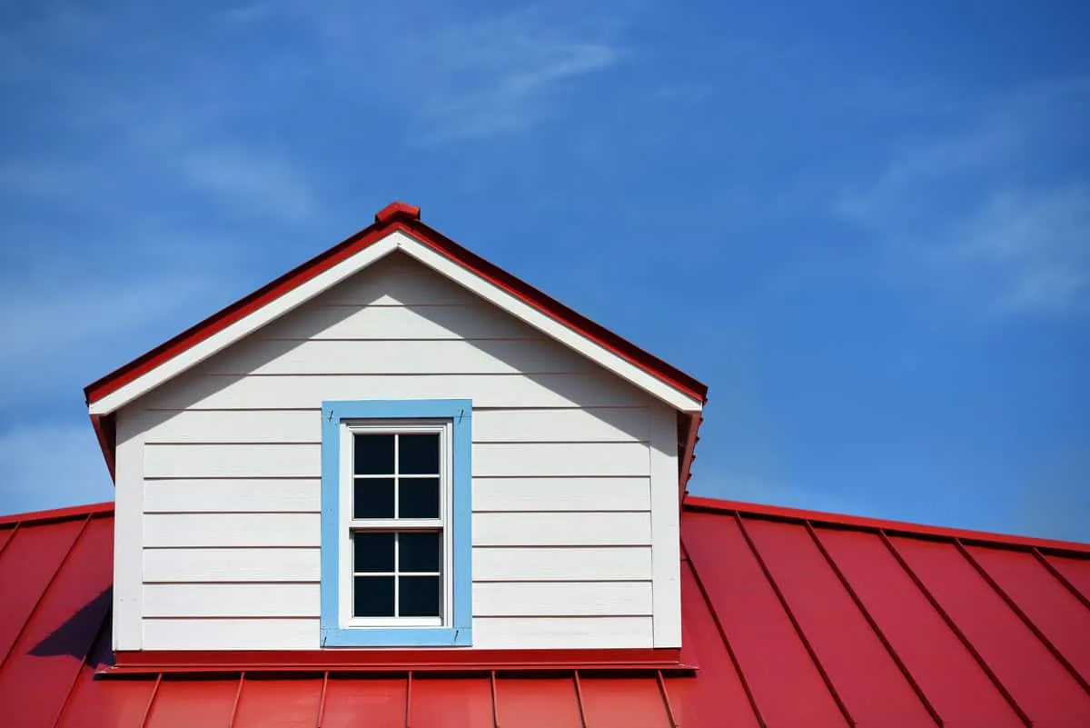 Red metal roofing against a South Texas sky