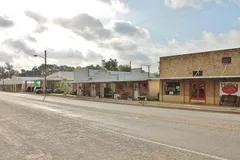 A row of one-story storefronts along a street in Stockdale.