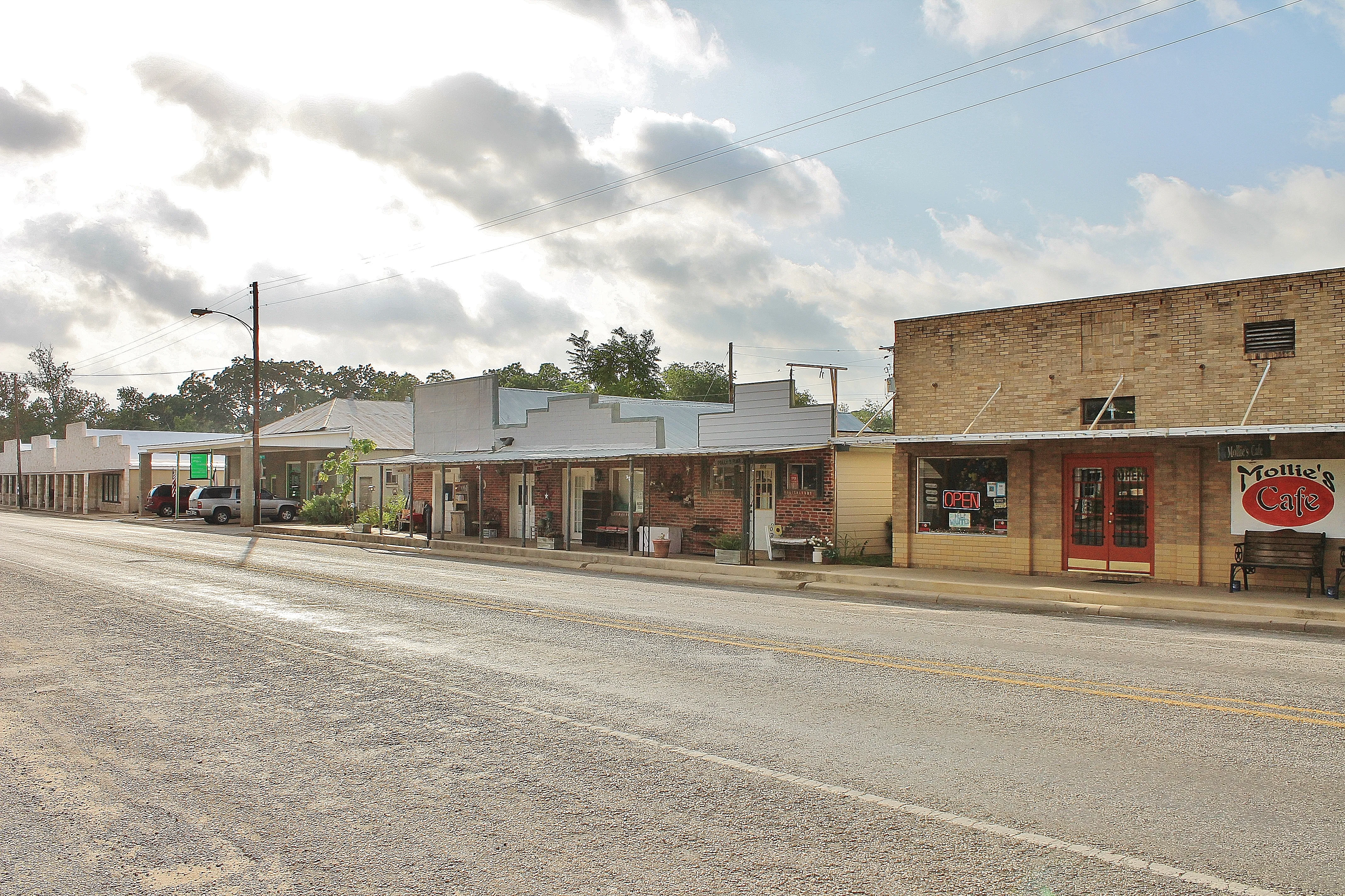 A row of one-story storefronts along a street in Stockdale.