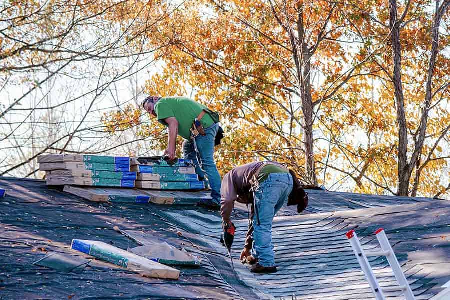 Professional Roofers working on replacing a roof