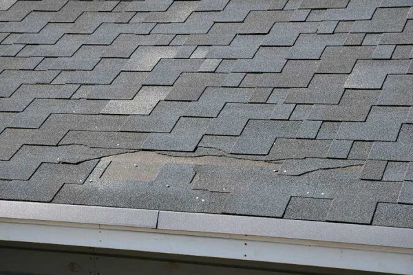 Roof with damaged shingles identified by our Cuero roofing company