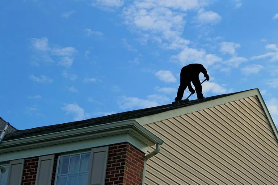 A Victoria TX Roofing professional inspecting a roof