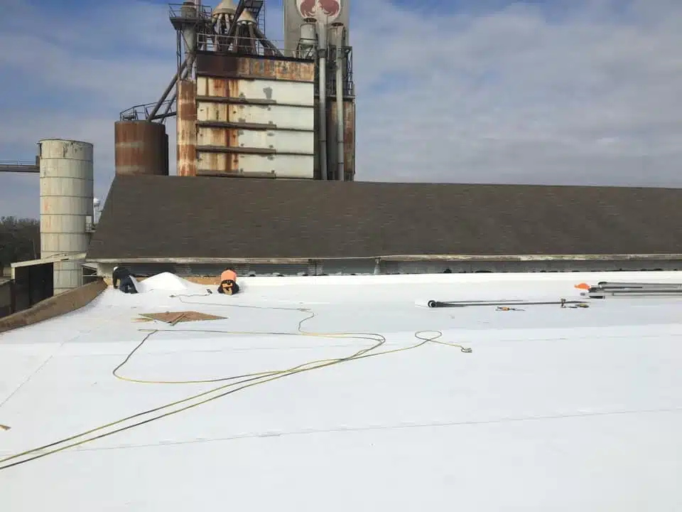 Workers installing white rooftop