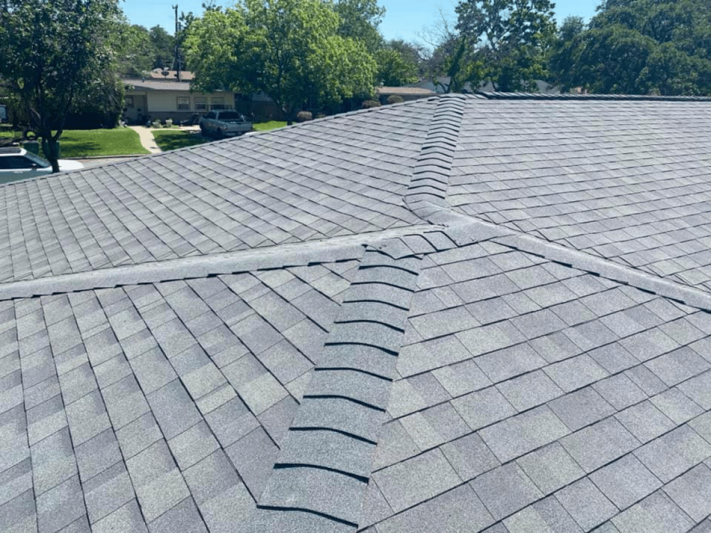 Close-up view of grey roof shingles with ridge detailing.