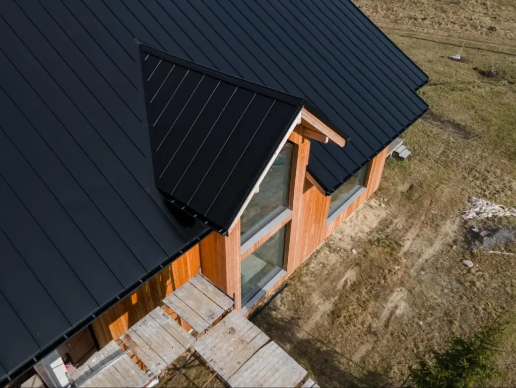 Metal Roof vs. Shingle in South Texas: What Lasts Longer in Hail and Heat 2 Black metal roof on home