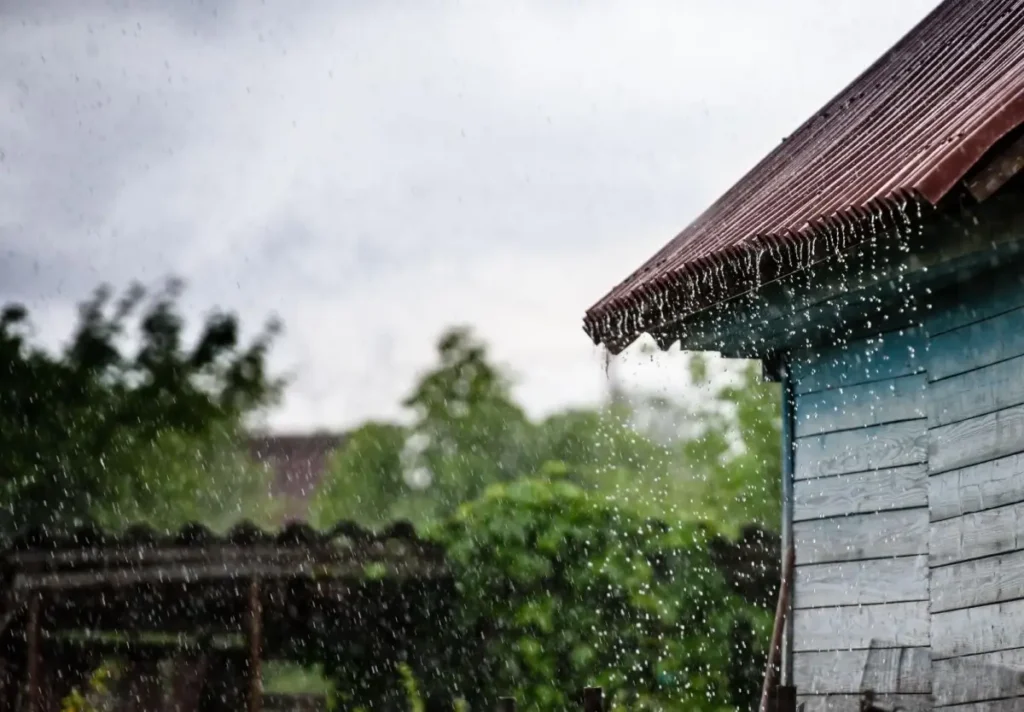 Why Some Roofers Offer 'Free Roofs' (And Why Texas Law Says That's Illegal) 3 Rainwater leaking from roof edge